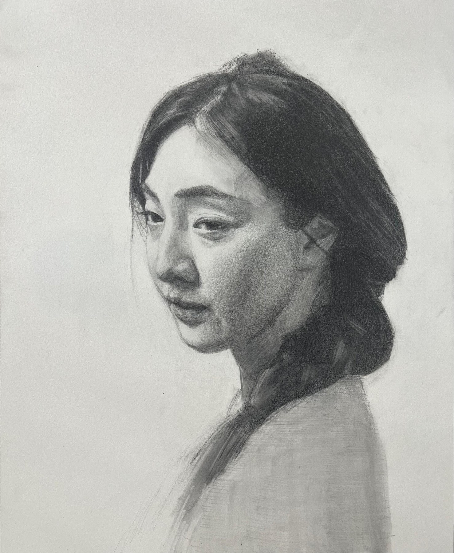 Graphite portrait of a woman, three-quarter view